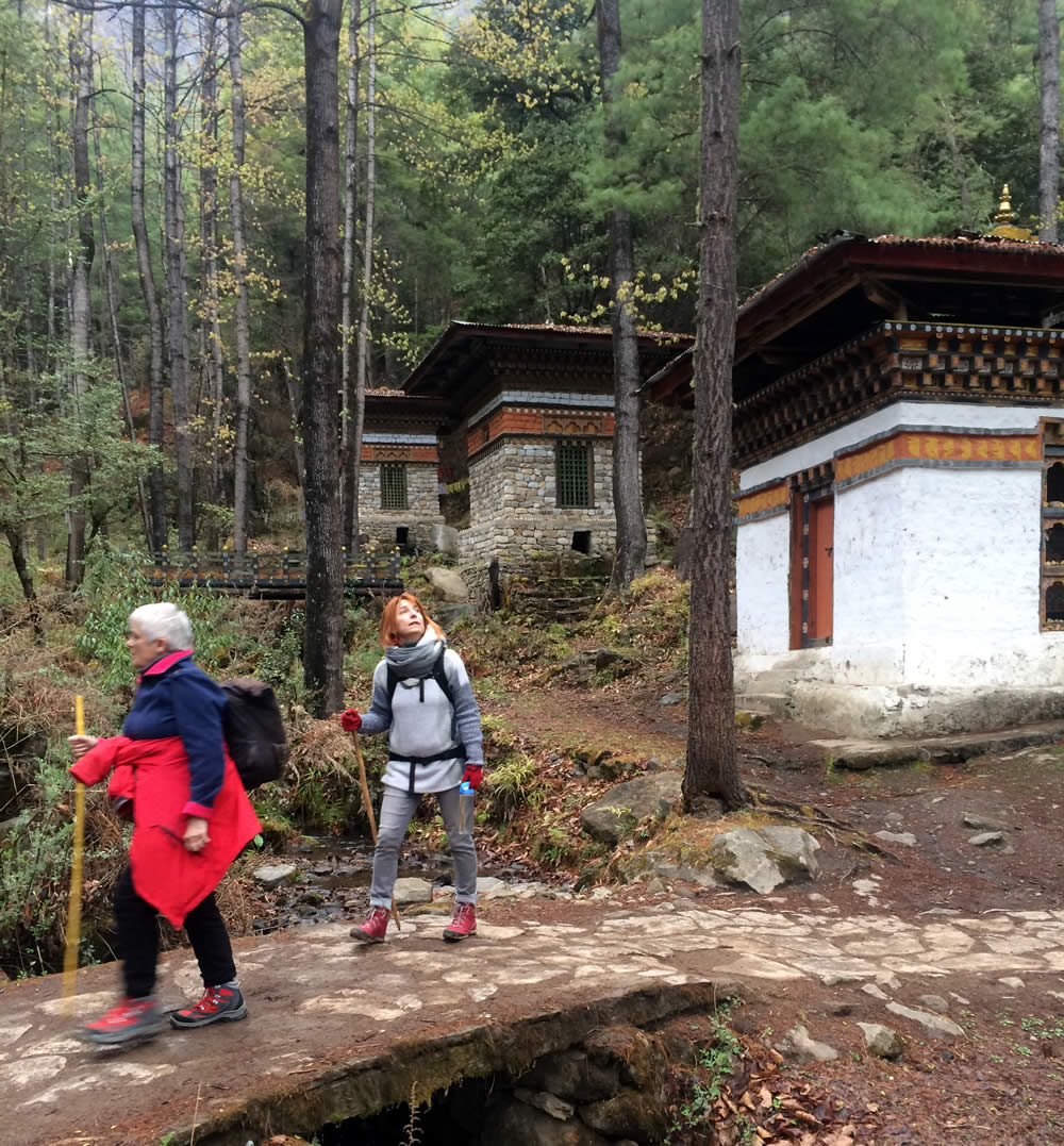 Hikers passing 3 small temples.