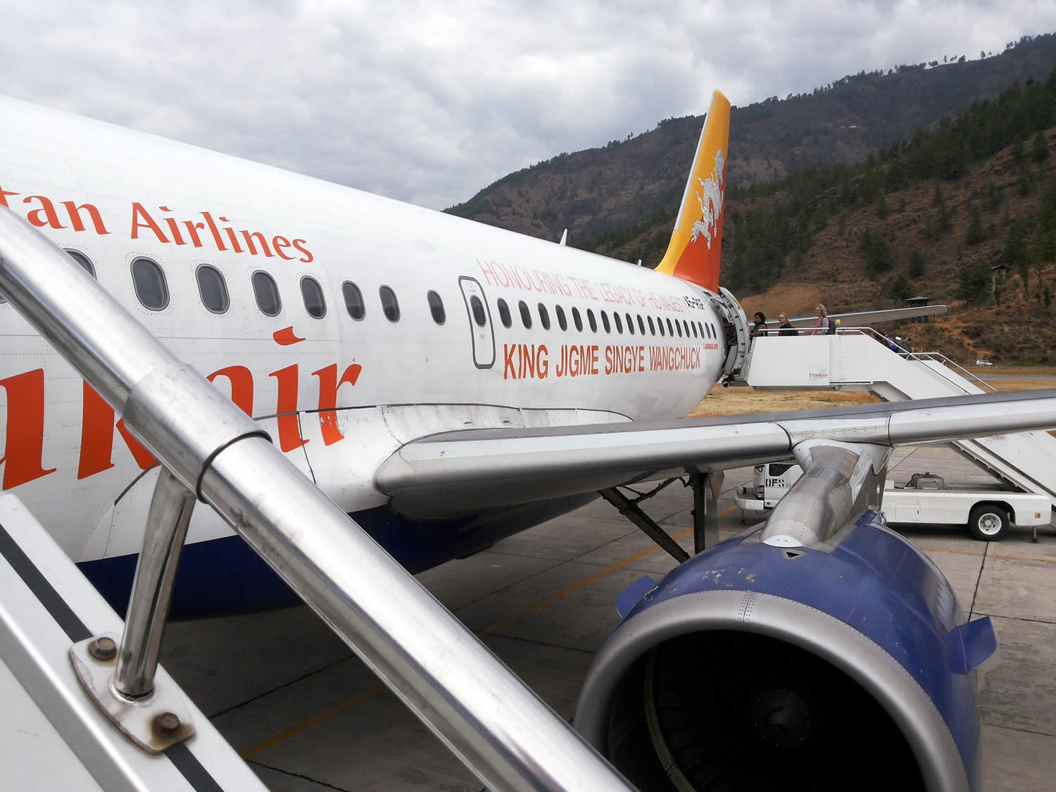 Group members board plane for flight from Paro to Delhi.
