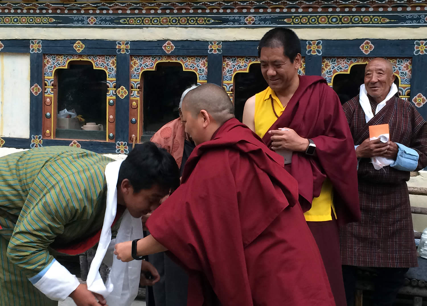 During a tea given by Lama Kunga la's family, khatags are offered to Jetsün Khandro Rinpoche while Kunga la and his father look on.
