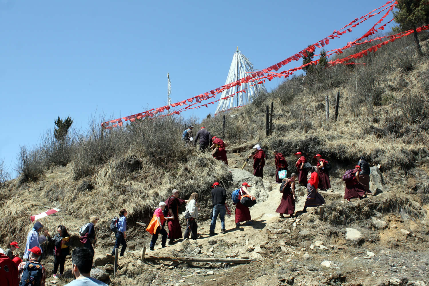 Jetsün Khandro Rinpoche leads the climb to Chödrak Monastery built at the site of Longchenpa's retreat cave.