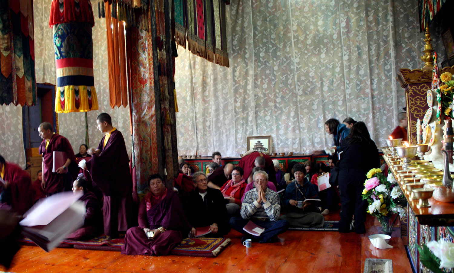 Offering prayers in the shrine room at Tharpaling Monastery.