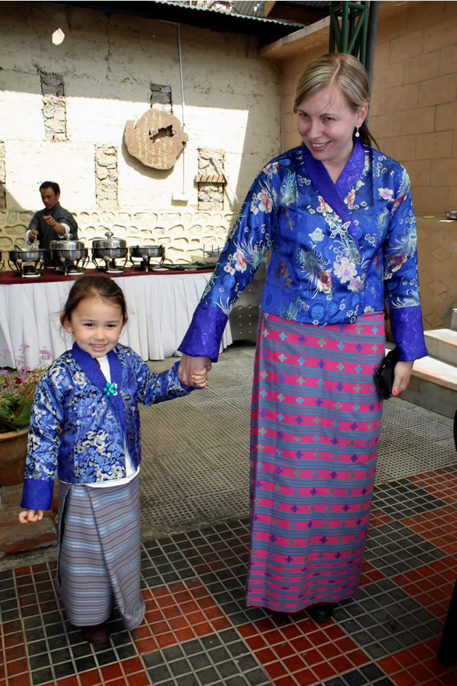 Jetsün Rinpoche and Lisa Cyrus showing off their traditional<em> Bhutanese garments for women called </em>kira.